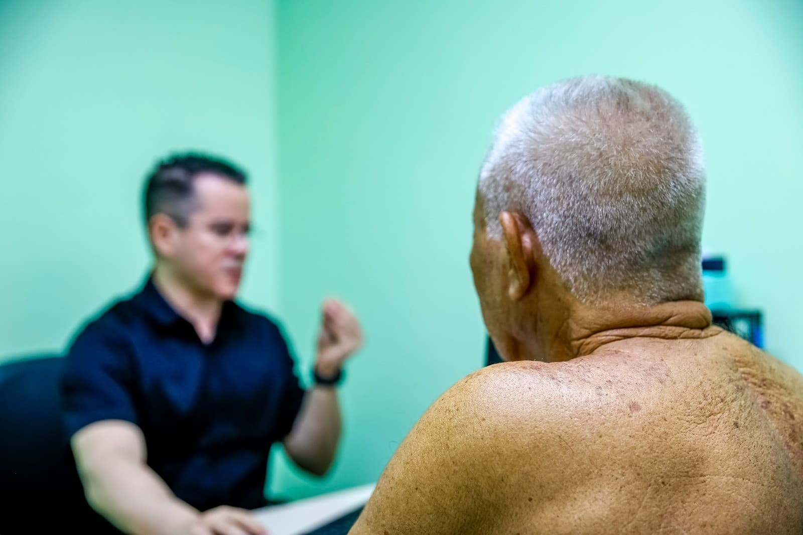 Hospital universitário com corredores e médicos atendendo pacientes.