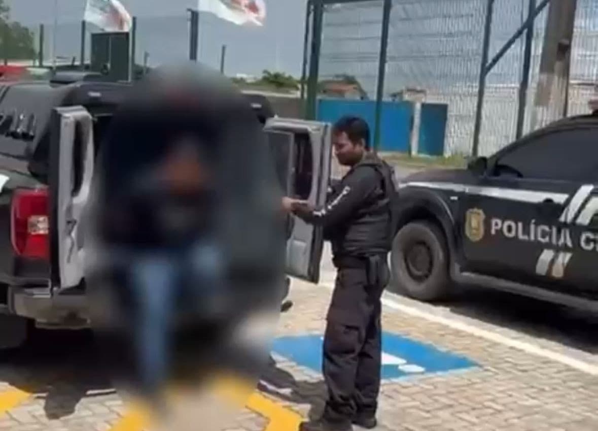 Viatura da Polícia Civil estacionada em via residencial de Macapá durante atendimento de ocorrência doméstica.